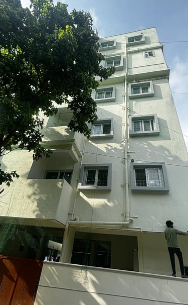 Brightly lit evening shot of safety nets glowing softly on a high-rise facade.