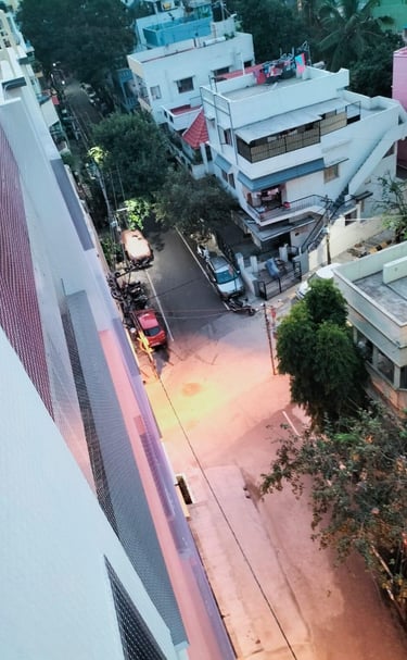 Safety net stretched tightly across a window opening, protecting workers below.