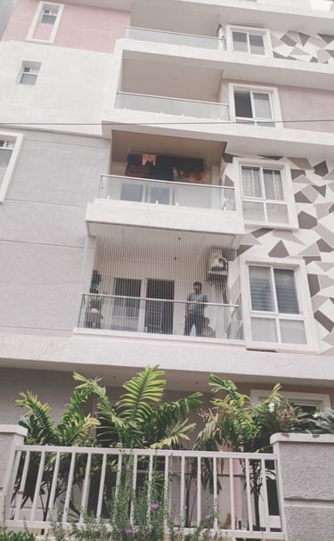 Close-up of a securely installed pigeon net on an apartment duct in Adyar.