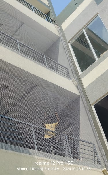 Close-up of a sturdy anti-pigeon net installed on a residential balcony in Besant Nagar.