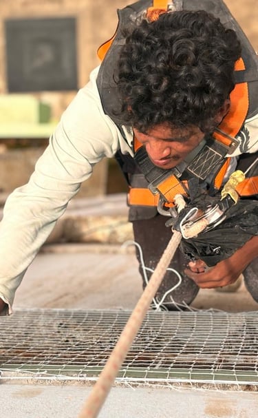 Balcony protected from pigeons, with a view of Haralur neighborhood in the background.