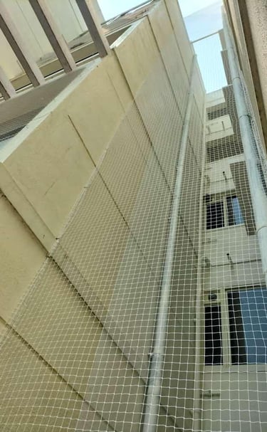 Technician from Arjilli Enterprises fitting a safety net on a duct area.