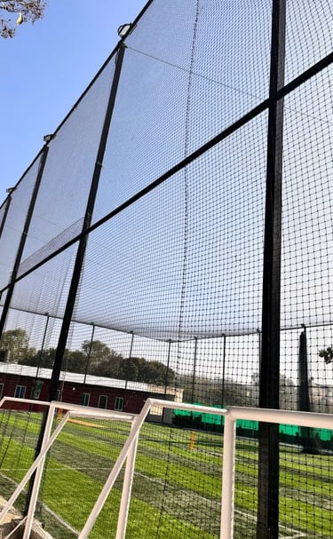 Technicians from Arjilli Enterprises carefully setting up a volleyball net in an outdoor Chennai par
