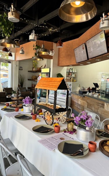 A table setting with Chai and Indian Desserts and Treats