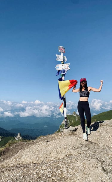 a woman standing on top of a mountain