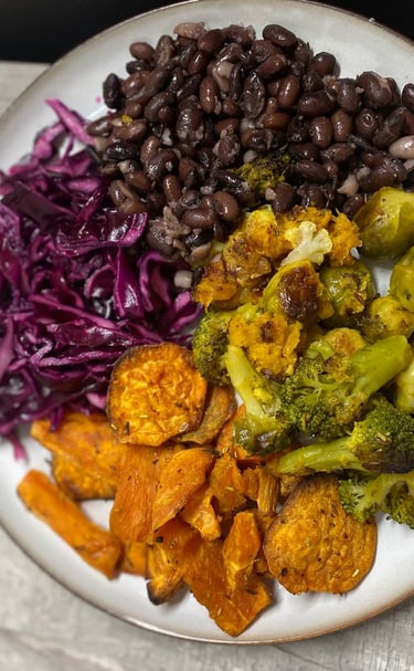 a plate of food with beans and vegetables