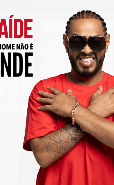a man with a tattoo on his arm and a red shirt