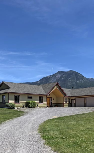 ground view of custom home drive way, Montana's Mission Mountains in the background by Saddlle Horn
