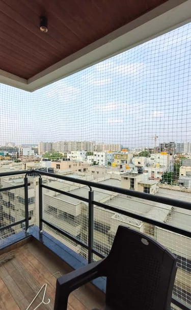 Close-up of a tightly woven pigeon net installed on a balcony in Bangalore.