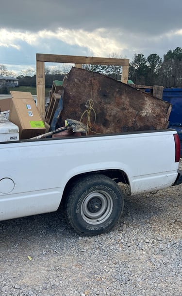 a truck with a large pile of junk in the back of it