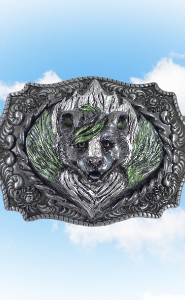 Ornate silver skunk head belt buckle on a green strap with a blue sky background.