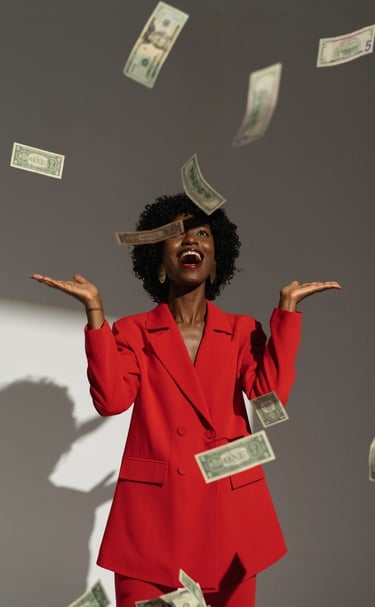 a woman in a red suit and sunglasses is standing in front of a wall with