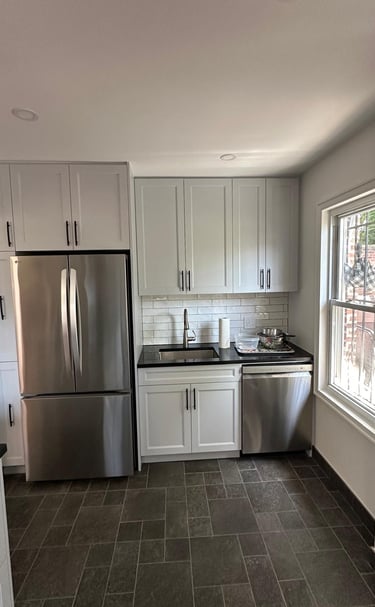 a kitchen with a refrigerator, stove, and refrigerator