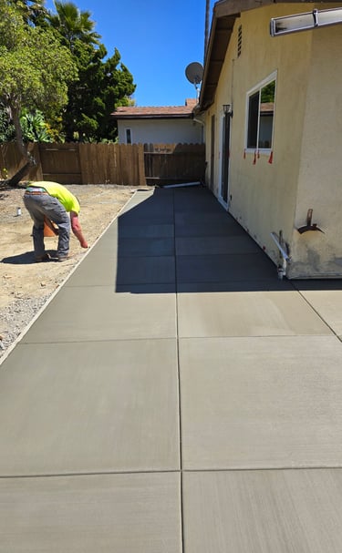 a man is finishing a concrete driveway