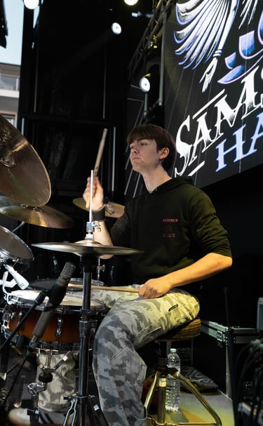 a man playing drums in a band