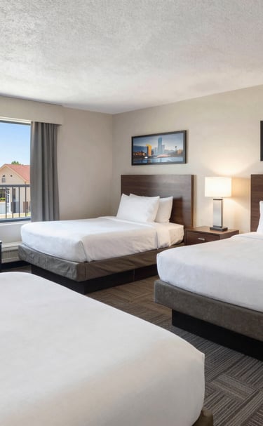 Cozy hotel lobby with comfy seating areas and warm lighting perfect for team gatherings.