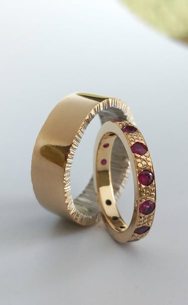 Hand fabricated wedding bands using 14kt yellow and white gold, set with Rubies by Kelly Allanson 