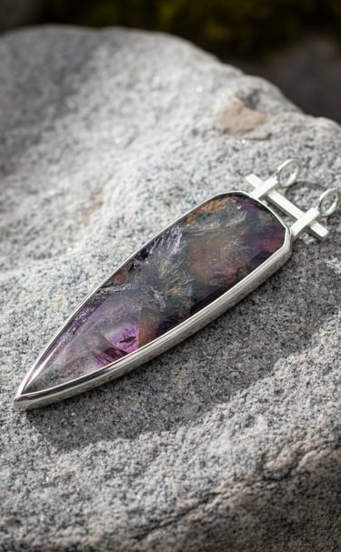 Hand Cut Super 7 cabochon set in sterling silver pendant by Kelly Allanson