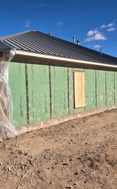 after the brick demolition begins with boarded windows by Red Dirt Ditching and Septic LLC