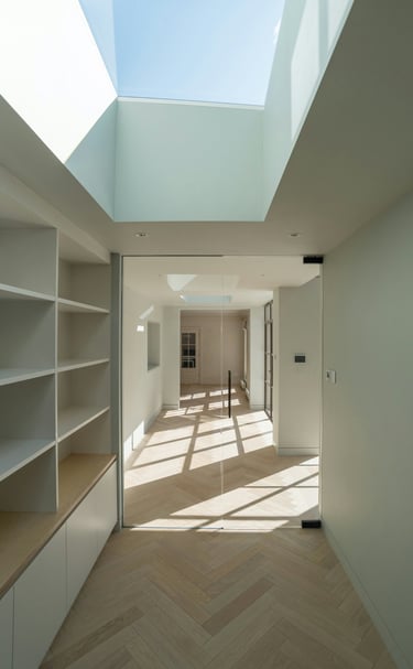 a room with a skylight and a wooden floor