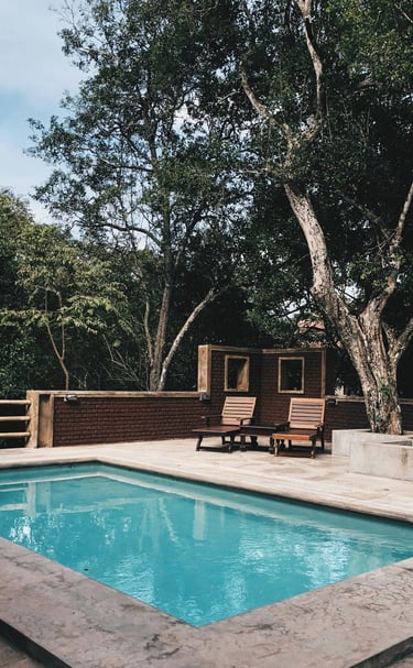 a pool with a tree in the background ingenieria ferram