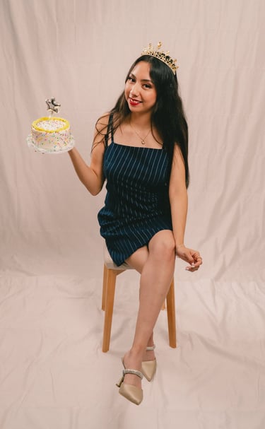 a woman in a dress and tiablet with a cake