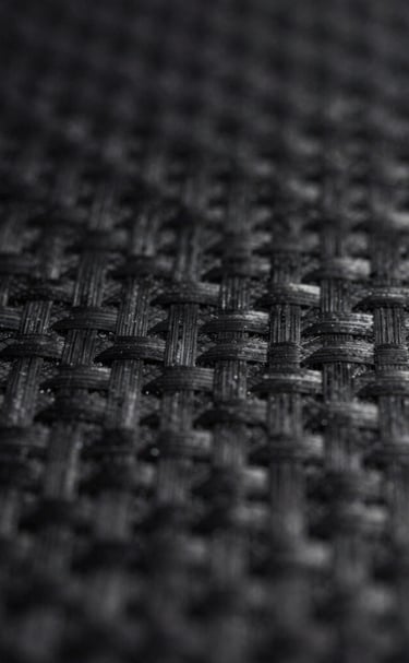 Texture-focused 8k image of dark, polished stone surface reflecting soft white light.