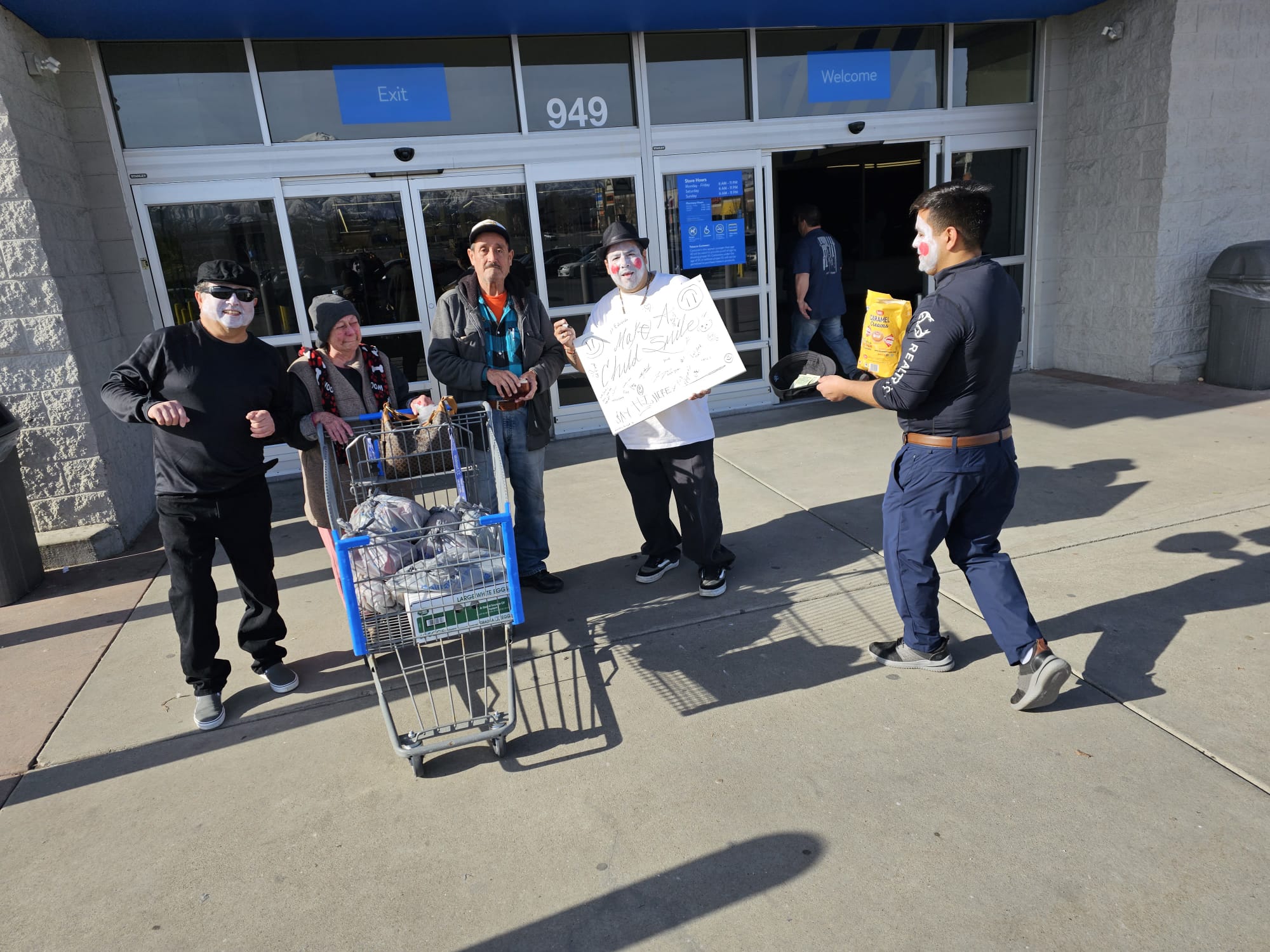 Mimes and shoppers standing with a grocery cart outside a store entrance.