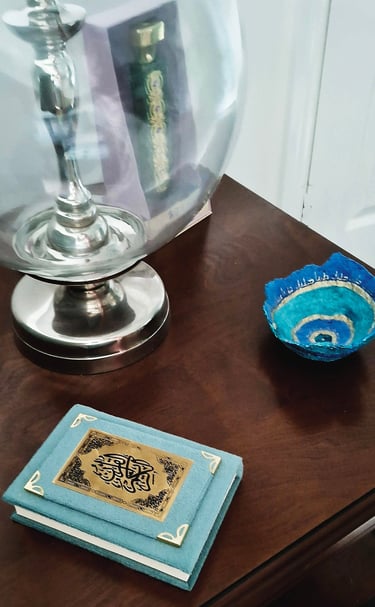 solid wood table with glass and metal lamp base and teal accessories