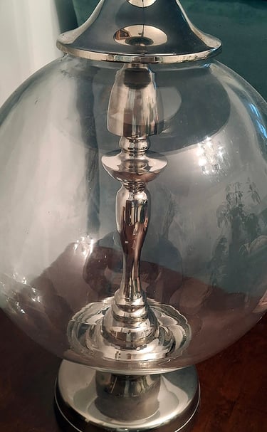 large glass and metal lamp base with a turquoise silk lamp shade