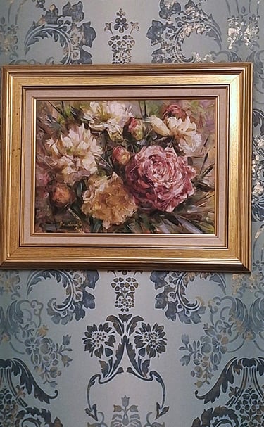 soft teal gilded wallpaper with a framed oil painting of beautiful blooms