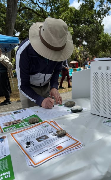 A person filling out a form at a table