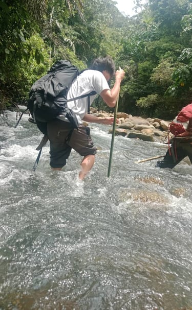 a man in a backpacker with a backpacker crossing the river 