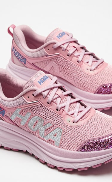 A cute collection of plush toys arranged on a cozy bed with ruffled blankets.