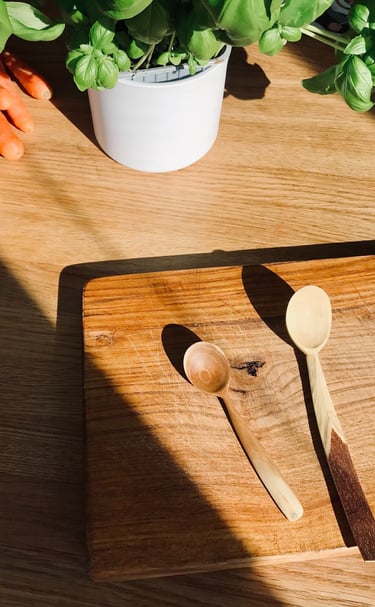 a wooden spoon and spoons on a table