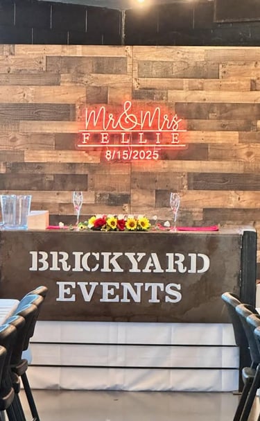 Wedding head table decorated with elegant place settings, floral arrangements, and soft lighting at 