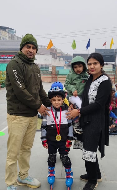 A proud family posing with a young boy wearing inline skates, a helmet, and a gold medal.