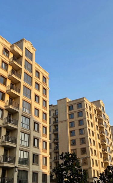Elegant high-rise luxury apartment building at sunset with warm lighting.