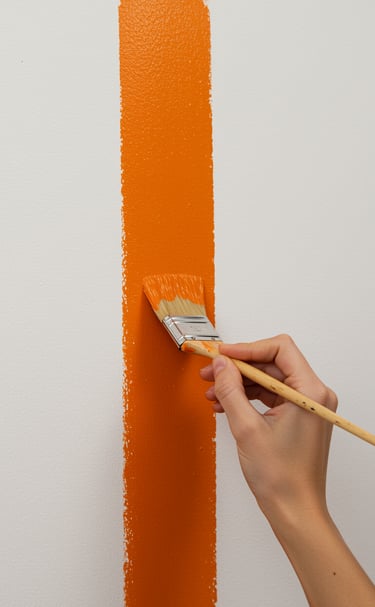 a person painting a wall with a paintbrush