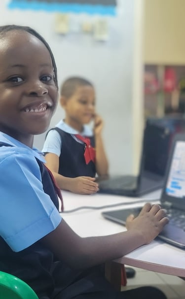 A kindergarten 2 pupil using the computer in a classroom