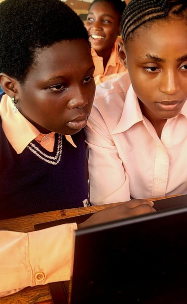 Girls using the computer at school