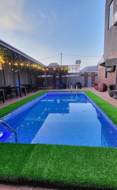 Outdoor swimming pool area with loungers.