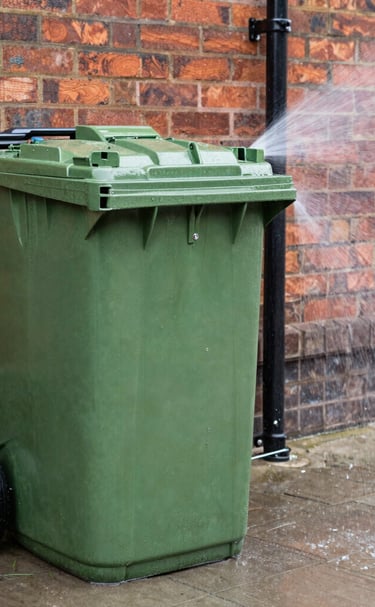 A row of spotless wheelie bins gleaming after a thorough wash.