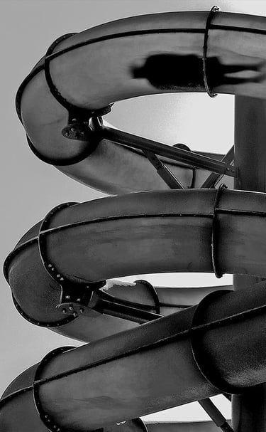 Black and white image of a person on a waterslide at Glenelg.