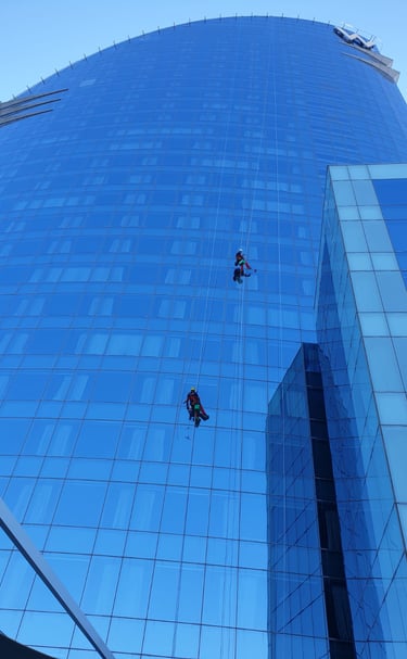 Two men hanging from a high riser