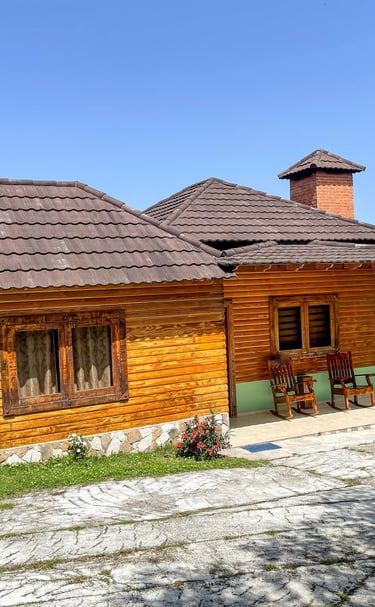 a wooden cabin with a brown roof and a brown roof