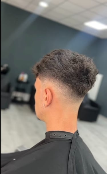 a man with a haircut and a haircut