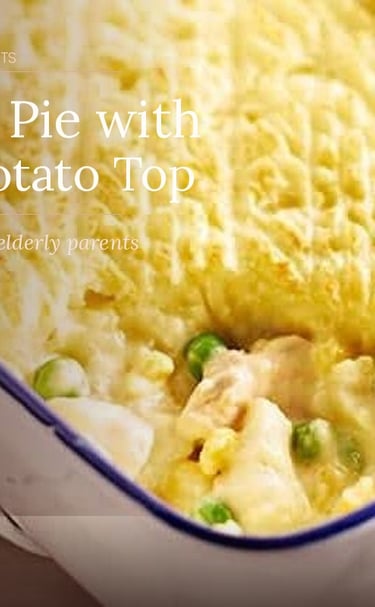 Easy fish pie with mashed potato top and peas in a white baking dish for elderly parents.