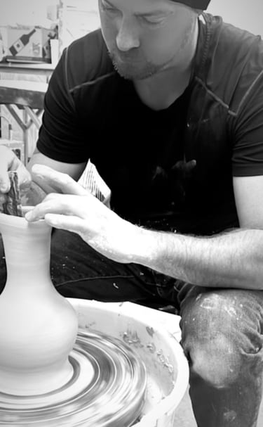 Ben Trammell throwing a clay vase on a wheel