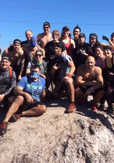 a group of people standing on top of a rock